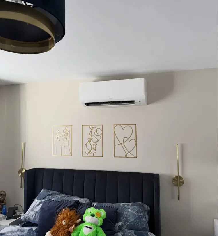 Air conditioning unit fitted above a bed in a family bedroom