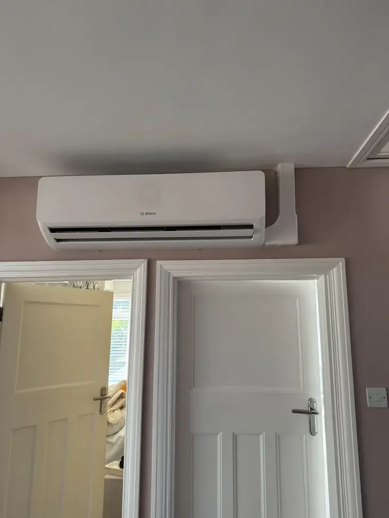 Bosch wall-mounted air conditioning unit fitted above a doorway on a landing