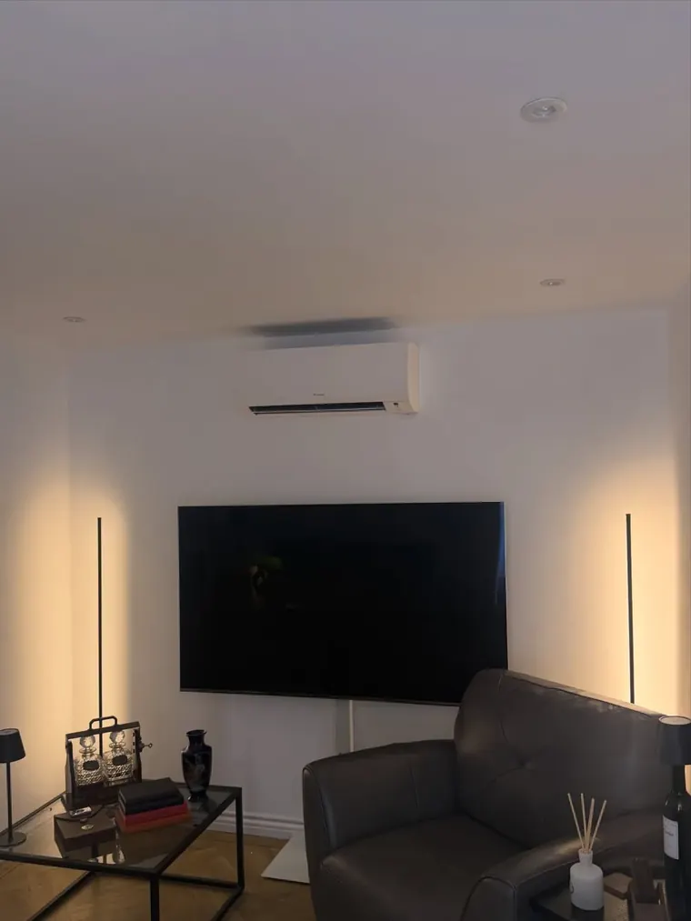 Air conditioning unit above a television in a lounge