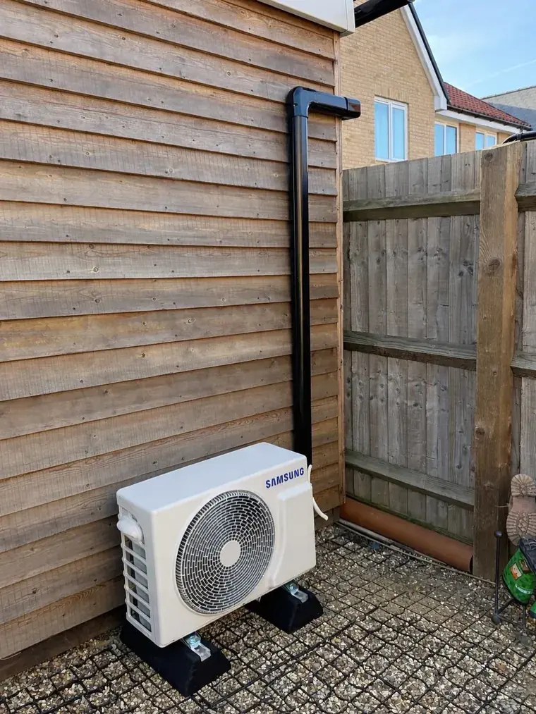 Samsung outdoor condenser unit mounted on a paved side return