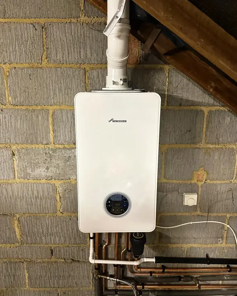 Worcester Bosch boiler installed on a brick wall in a loft space