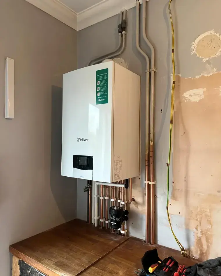 Newly installed Vaillant boiler with copper pipework below it