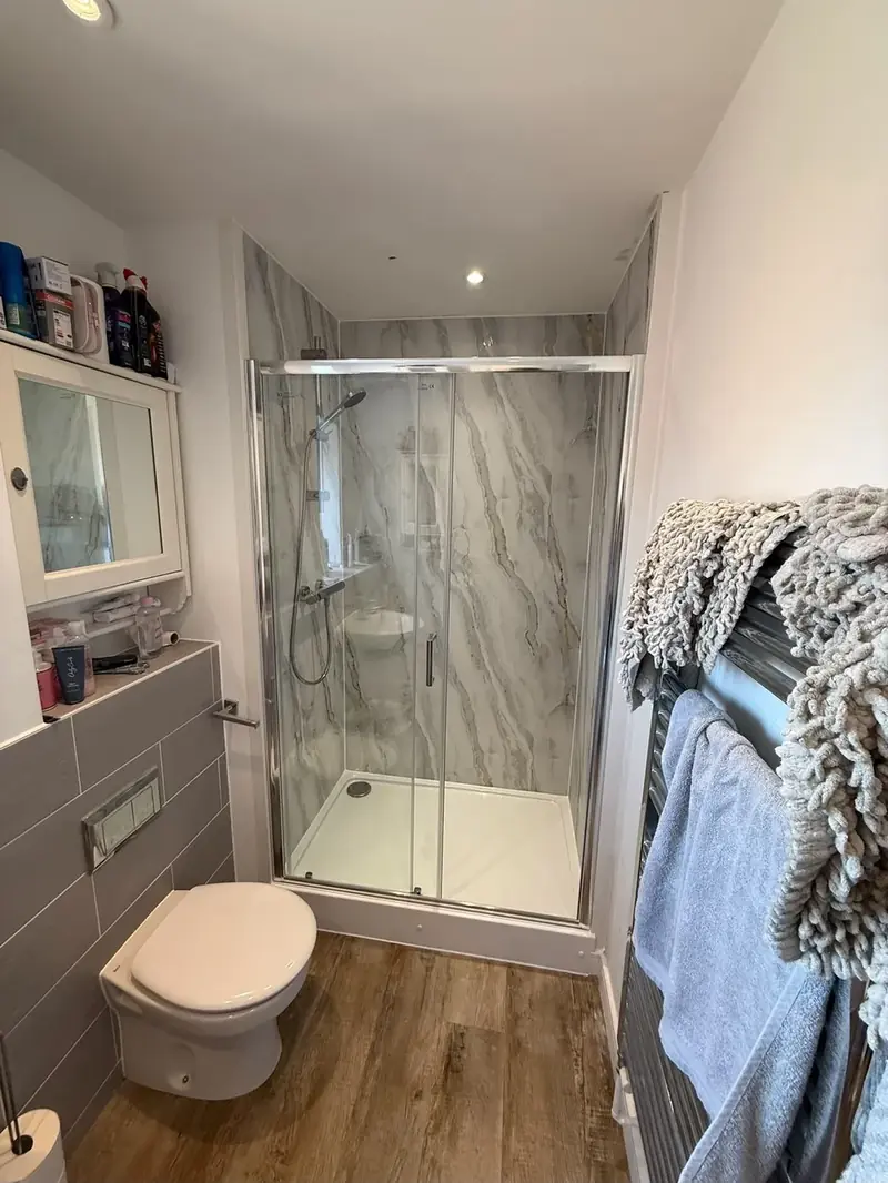 Finished bathroom with a shower enclosure, vanity unit and heated towel rail