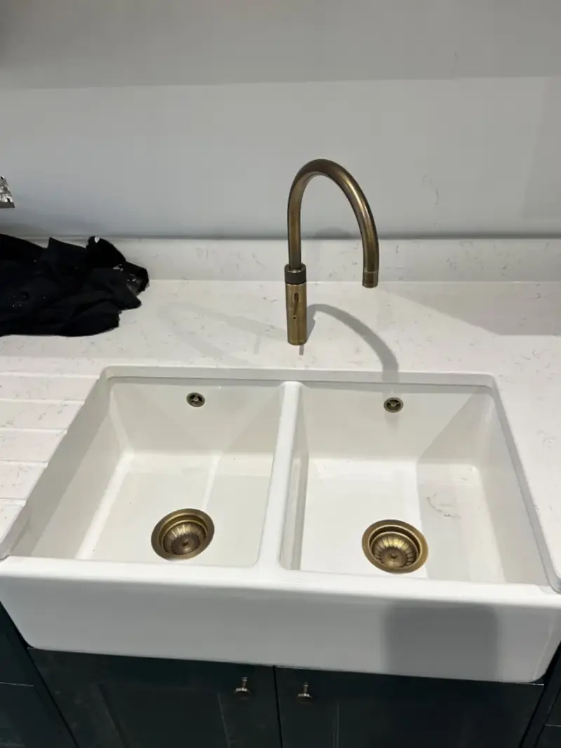 Double butler sink with a brass mixer tap, plumbed in and finished